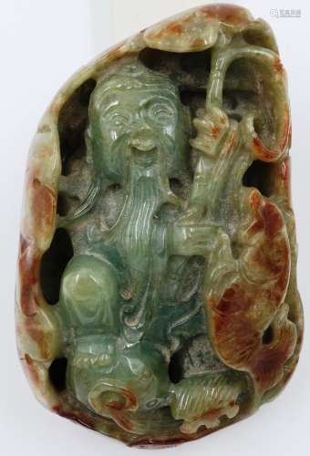 A Ming Dynasty celadon and brown jade figure of a deity, his...