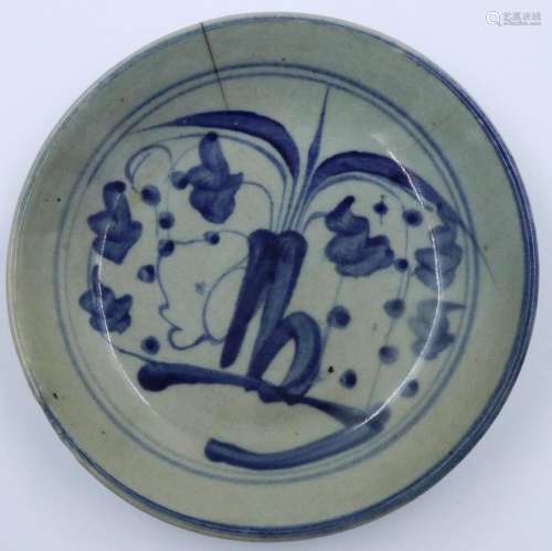 A Ming Dynasty shallow dish, circular and glazed with blue p...