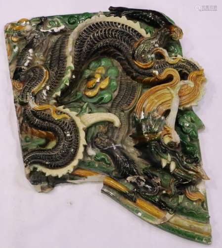 A Ming Dynasty Sancai-glazed tile panel, the coiled dragon c...