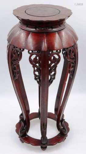 A 20th century cherrywood vase stand, having simplistic carv...