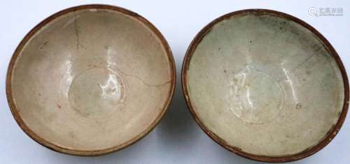 A pair of Tang Dynasty celadon glazed bowls, one with painte...
