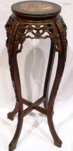 A 19th century padouk wood vase stand, heavily carved with c...