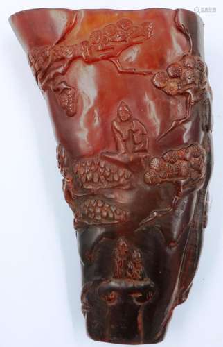 A carved buffalo libation cup, decorated with a tree framing...