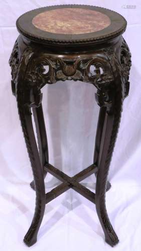 A 19th century padouk wood vase stand, heavily carved with c...