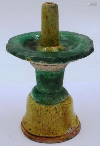 A Ming Dynasty glazed candle stick, the taper holder conical...