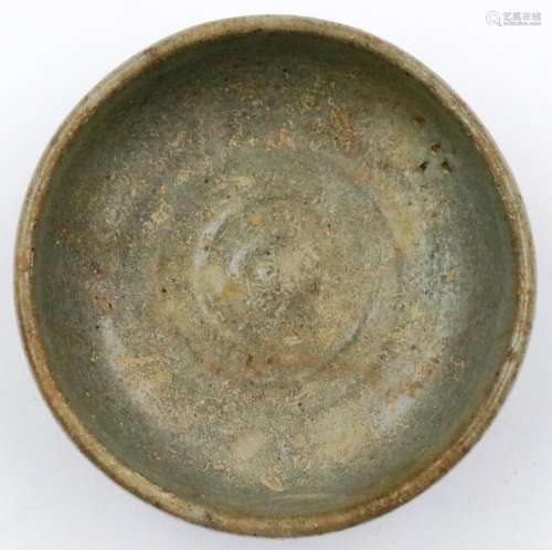 A Ming Dynasty celadon glazed footed bowl of diminutive prop...