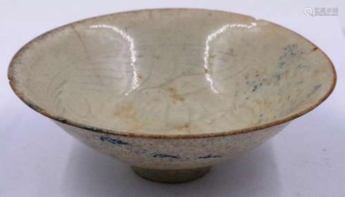 A celadon glazed porcelain bowl having incised decoration to...