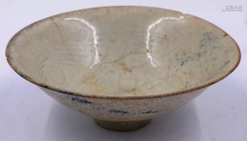 A celadon glazed porcelain bowl having incised decoration to...