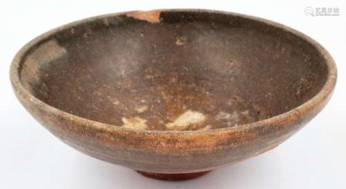 A large Song Dynasty bowl, tapered and footed, glazed in bro...