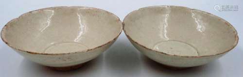 A pair of Ming Dynasty glazed bowls, each footed with shaped...