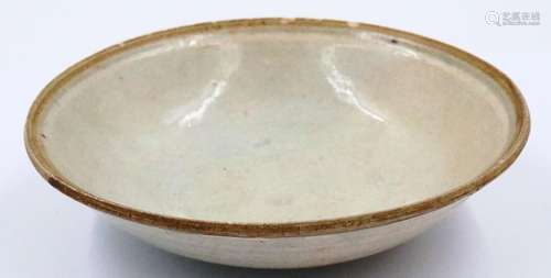 A celadon glazed Ming Dynasty shallow bowl, footed, D: 15 cm...