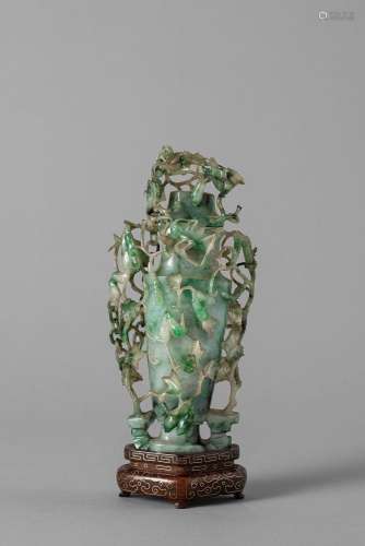An apple green jade vase with cover. China, late Qing dynast...