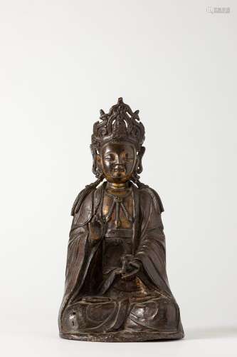 A lacquered and partially gilt bronze Guanyin. China, Ming d...