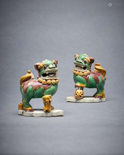 A pair of Chinese glazed biscuit Buddhist lion joss-stick ho...