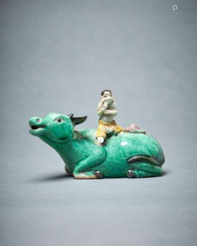 A Chinese biscuit glazed water dropper model of a boy seated...
