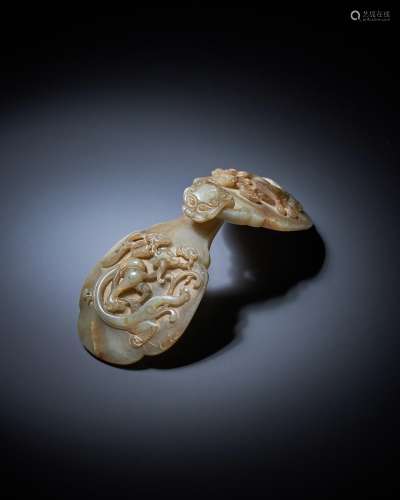 A Chinese celadon and brown jade buckle