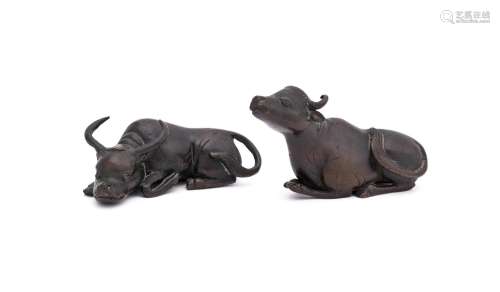 Two Chinese bronze scroll weights of buffalo