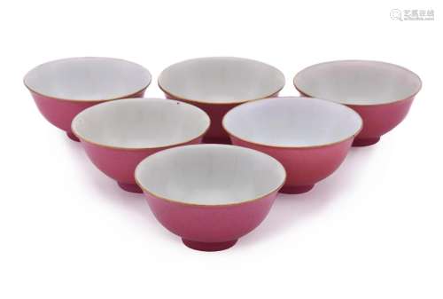 A set of six small ruby-red bowls