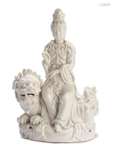 A CHINESE DEHUA FIGURE OF GUANYIN SEATED ON A LION
