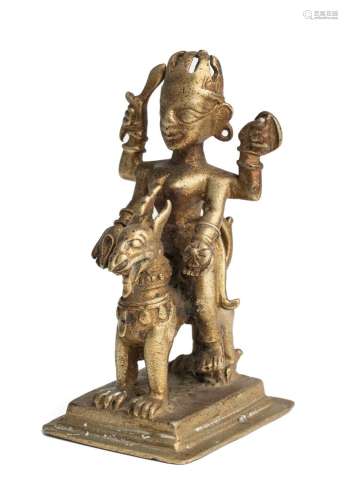 A BRONZE FIGURE OF DURGA RIDING ON HER LION