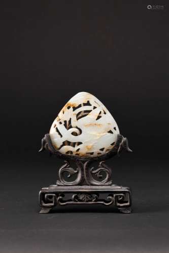 A CHINESE CELADON AND RUSSET JADE OPENWORK PLAQUE PROBABLY Y...