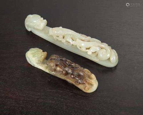 Two jade belt hooks Chinese, 19th Century comprising of a wh...