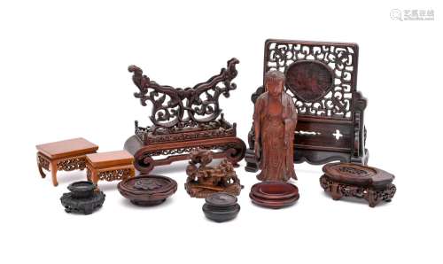 A group of Chinese wood stands and a boxwood figure of Buddh...
