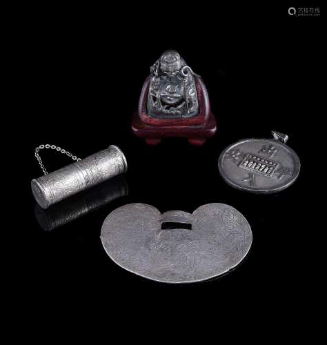 A group of four silver pendants and emblems