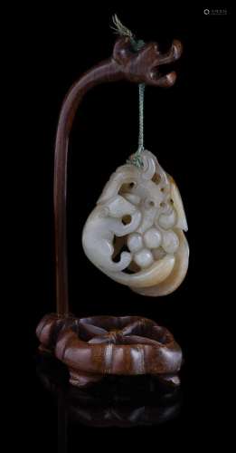 A Chinese pale celadon jade 'squirrel and grapes' pendant