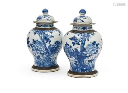 A pair of Chinese blue and white vases and covers