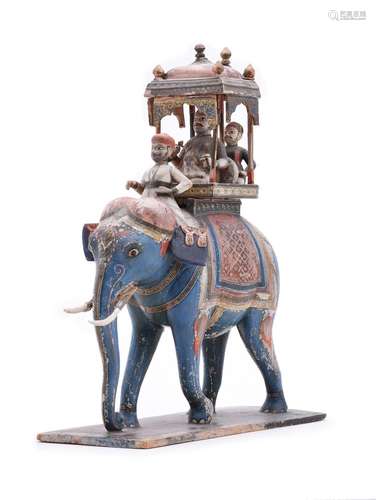 An Indian carved and painted wood group of an elephant and r...