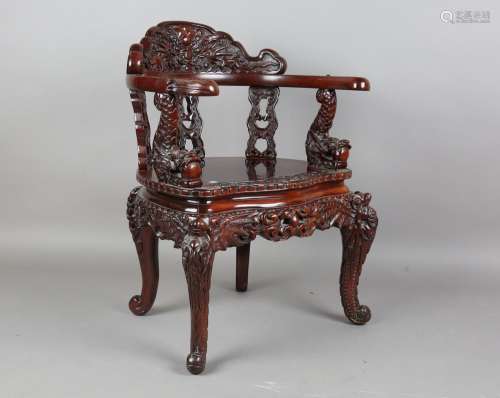 A Japanese carved and stained softwood tub back chair