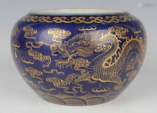 A Chinese gilt decorated blue glazed porcelain jar of squat ...