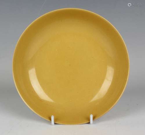 A Chinese yellow glazed porcelain circular saucer dish