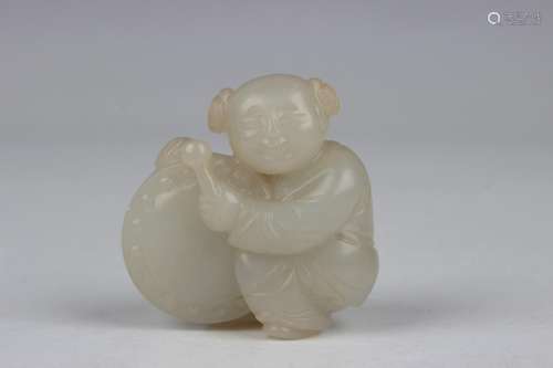 A Chinese pale celadon carving of a boy with drum