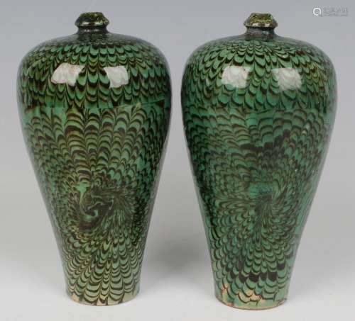 A pair of Chinese green and black marble glazed porcelain me...