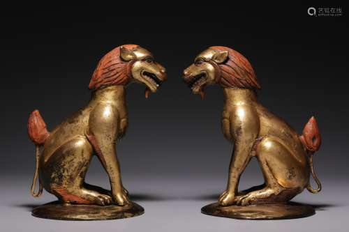 Qing Dynasty, a pair of bronze gilt snow lion ornaments