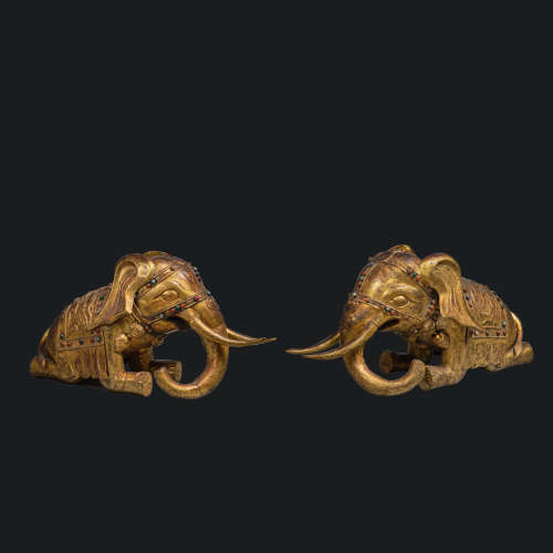 A pair of elephants inlaid with gold and precious stones fro...