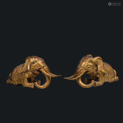 A pair of elephants inlaid with gold and precious stones fro...