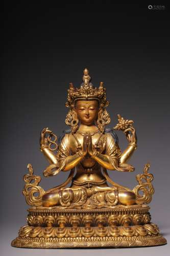 A bronze gilt statue of Guanyin with four arms in Qing Dynas...