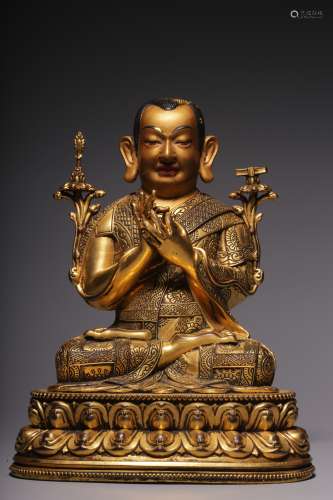 In the Qing Dynasty, a sitting bronze gilt statue of a maste...