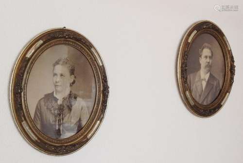 Pair of oval picture frames with antique photos,stucco,aroun...