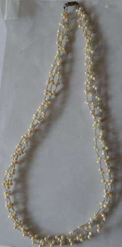 Long white pearl necklace with small pearls strung on wire