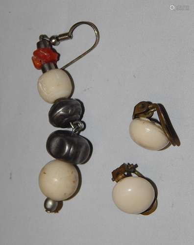 Pair of ear clips and a single earring with leg trim