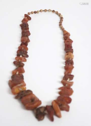 Long amber necklace with natural stones and small wooden bea...