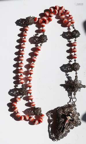 Long rosary with orange/white glass beads and filigree worke...