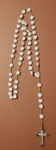 Long rosary with white beads decorated with floral half reli...