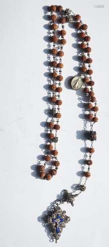 Long rosary with carved wooden beads and filigree worked sil...