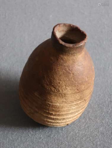 Antique pot with grooved decoration