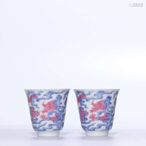 A PAIR OF RUBY-RED BLUE AND WHITE 'DRAGON' CUPS.QING DYNASTY